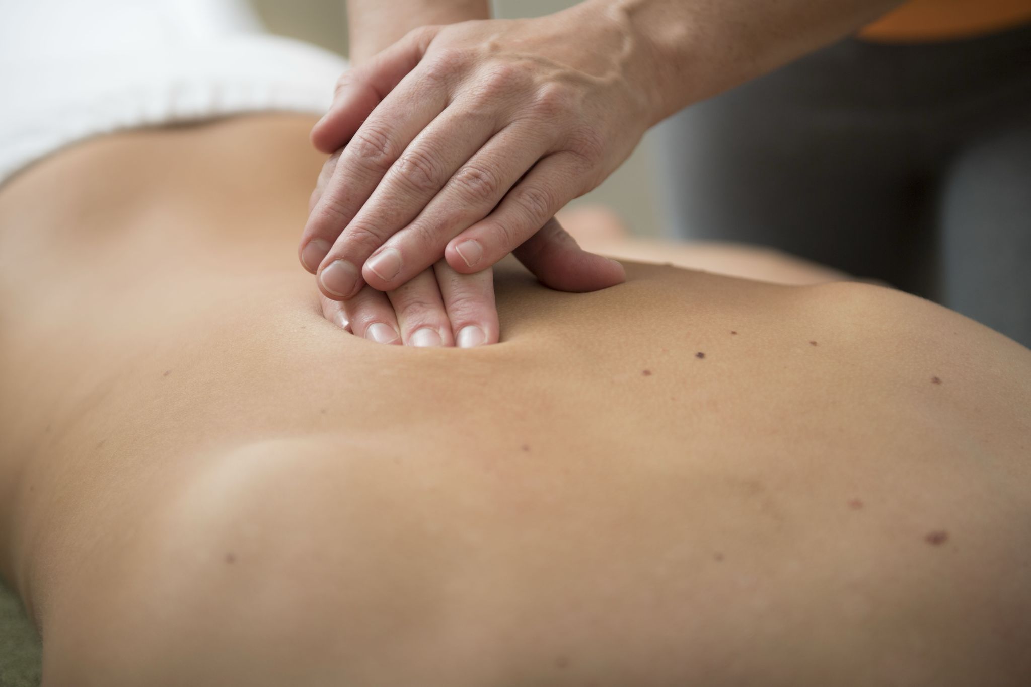 Massage therapist working on client